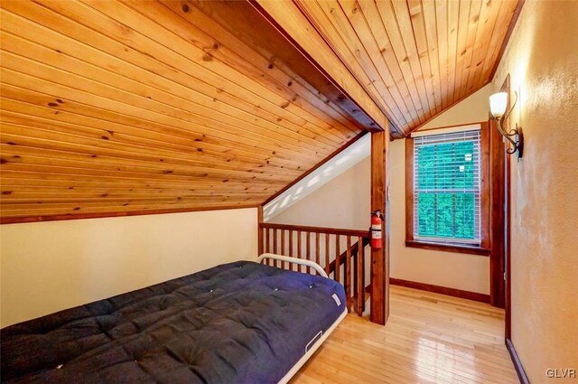 bedroom featuring wooden ceiling, lofted ceiling, and light hardwood / wood-style floors