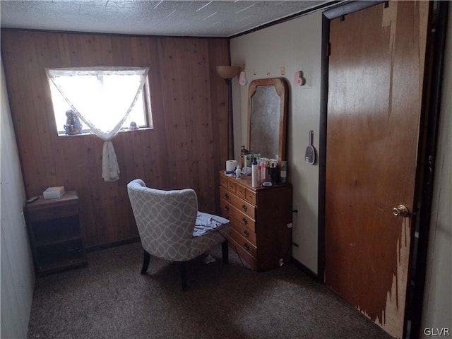 home office with carpet floors and wooden walls