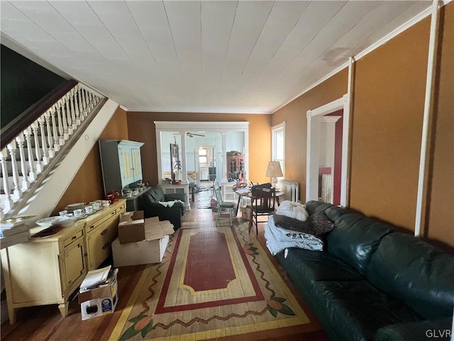 living room featuring crown molding, ceiling fan, and wood-type flooring