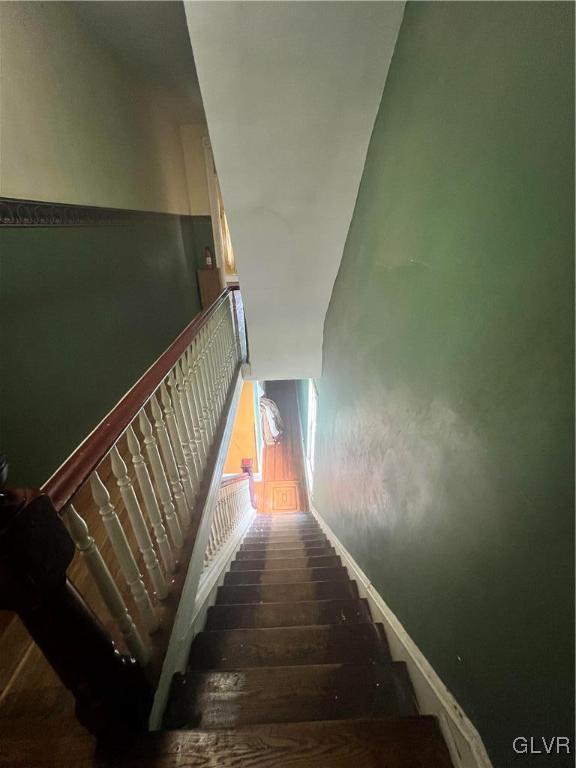 stairs featuring hardwood / wood-style floors