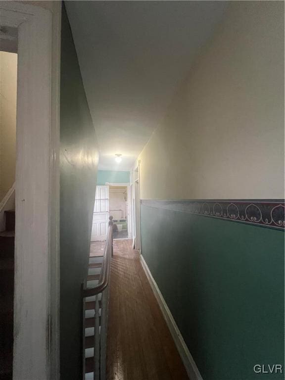 hallway with hardwood / wood-style floors