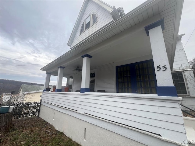 view of side of property featuring covered porch