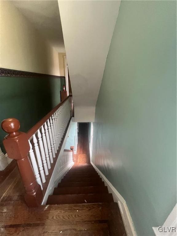 staircase with wood-type flooring