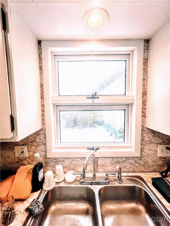 55 S Walnut St, Lansford Borough, PA 18232 - room details featuring backsplash, a sink, and light countertops