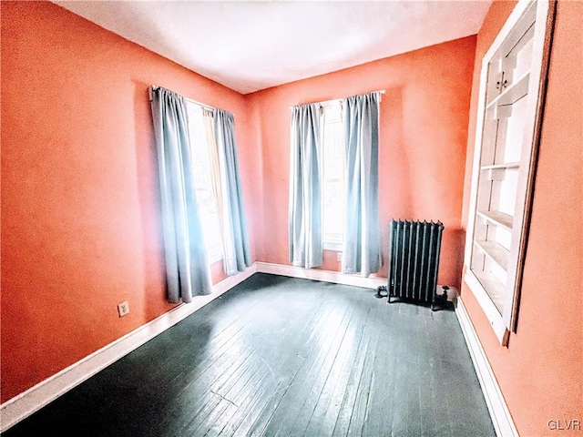 55 S Walnut St, Lansford Borough, PA 18232 - spare room featuring dark wood-style flooring, baseboards, and radiator heating unit