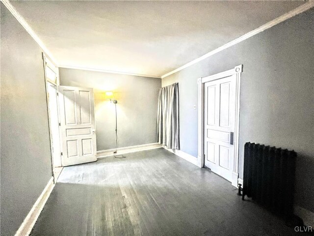 55 S Walnut St, Lansford Borough, PA 18232 - unfurnished bedroom featuring ornamental molding, radiator heating unit, wood finished floors, and baseboards