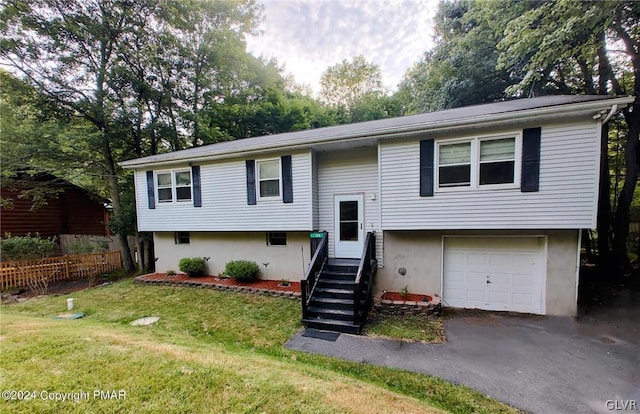 split foyer home with a garage and a front lawn