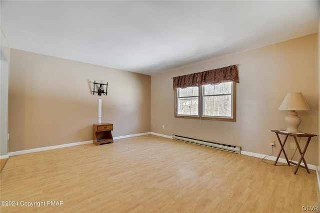 unfurnished room featuring light hardwood / wood-style floors and a baseboard radiator