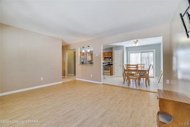 spare room featuring light wood-type flooring and ceiling fan