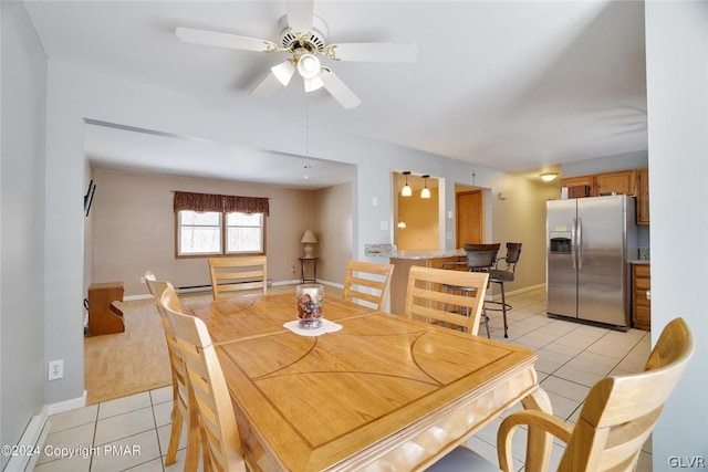 tiled dining area featuring ceiling fan