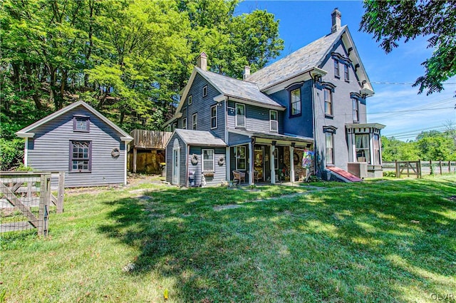 rear view of house with a lawn