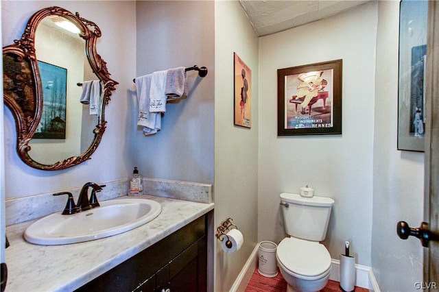 bathroom featuring toilet and vanity