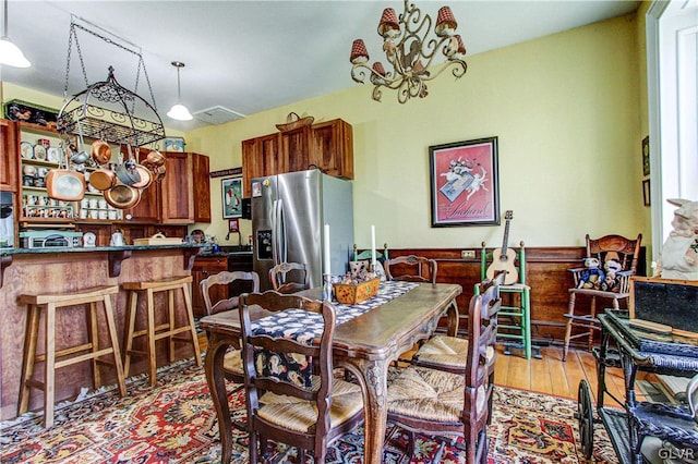 dining space featuring an inviting chandelier and light wood-type flooring