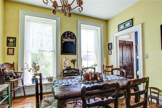 dining space featuring an inviting chandelier and hardwood / wood-style flooring