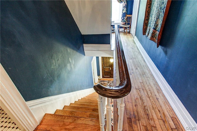 staircase with light hardwood / wood-style floors