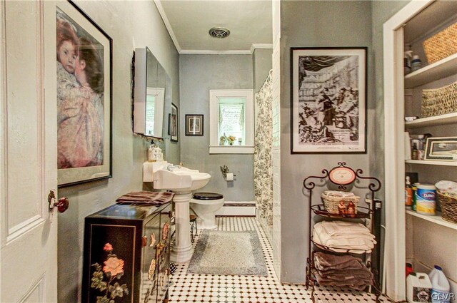 bathroom with crown molding, sink, toilet, baseboard heating, and tile patterned flooring