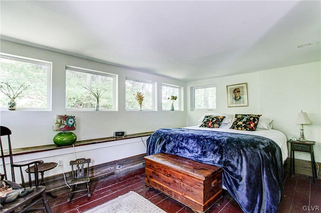 bedroom with dark hardwood / wood-style flooring