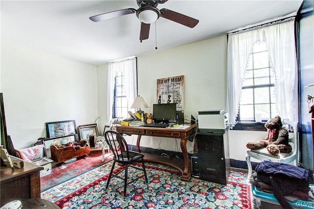 home office with wood-type flooring and ceiling fan