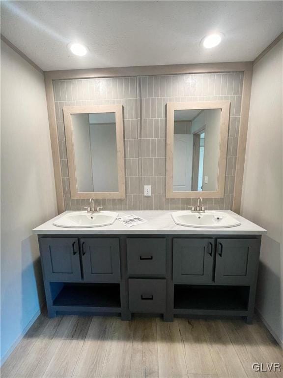 3444 Franklin Sq, Moore Twp, PA 18067 - full bath with wood finished floors, double vanity, and backsplash