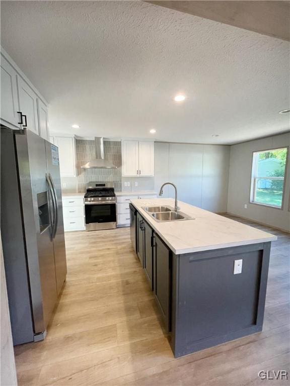 3444 Franklin Sq, Moore Twp, PA 18067 - kitchen with stainless steel appliances, wall chimney exhaust hood, light wood-style floors, light countertops, and white cabinets