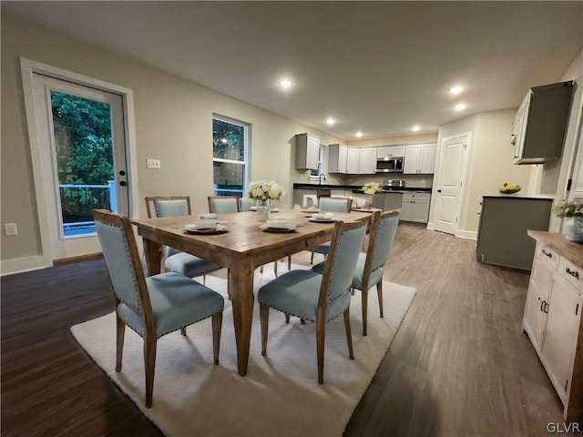 dining area featuring hardwood / wood-style flooring and sink