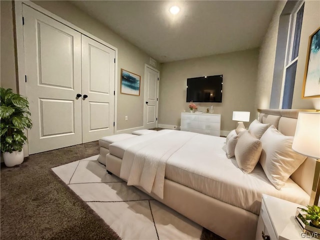 bedroom with a closet and light colored carpet