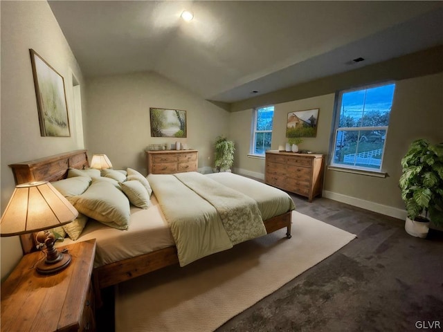 carpeted bedroom with vaulted ceiling