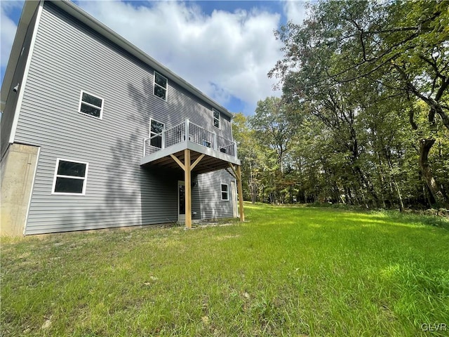 rear view of property featuring a yard