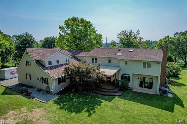 rear view of property with a yard