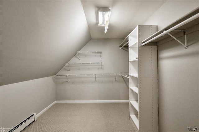 walk in closet featuring baseboard heating, carpet, and lofted ceiling