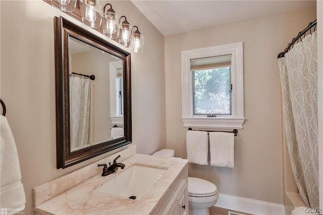 bathroom featuring toilet and vanity