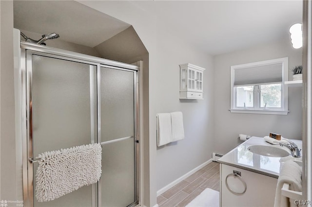 bathroom featuring vanity, an enclosed shower, and a baseboard heating unit