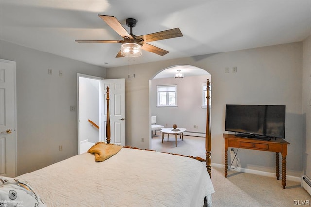 carpeted bedroom featuring baseboard heating and ceiling fan