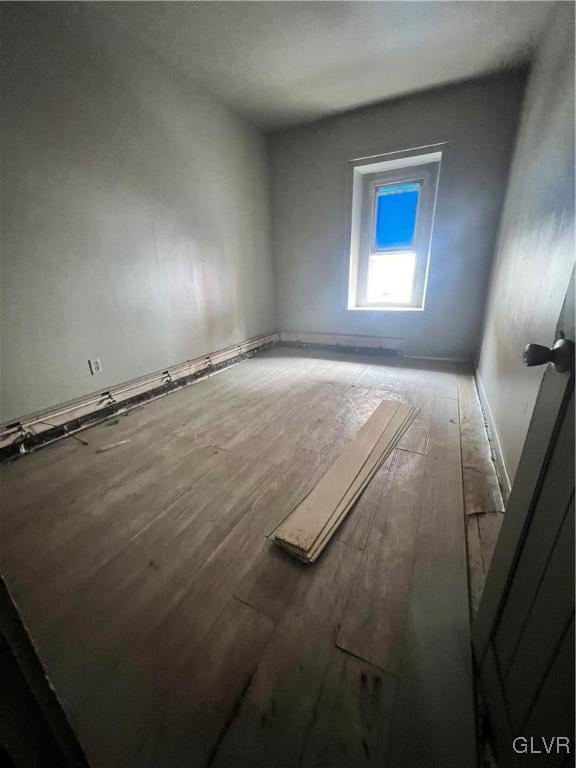 empty room with wood-type flooring