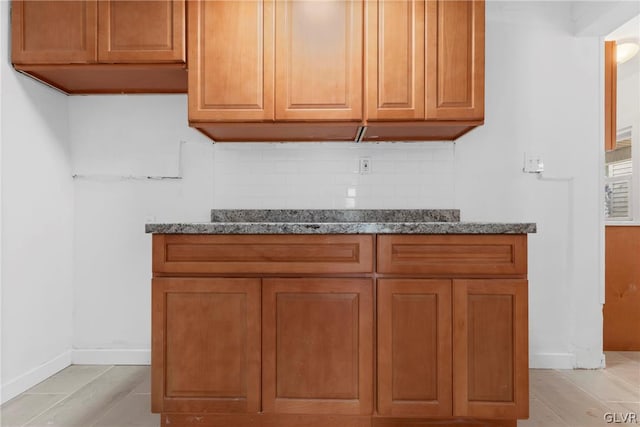 kitchen with tasteful backsplash and stone counters