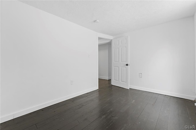 unfurnished room featuring a textured ceiling and dark wood-type flooring