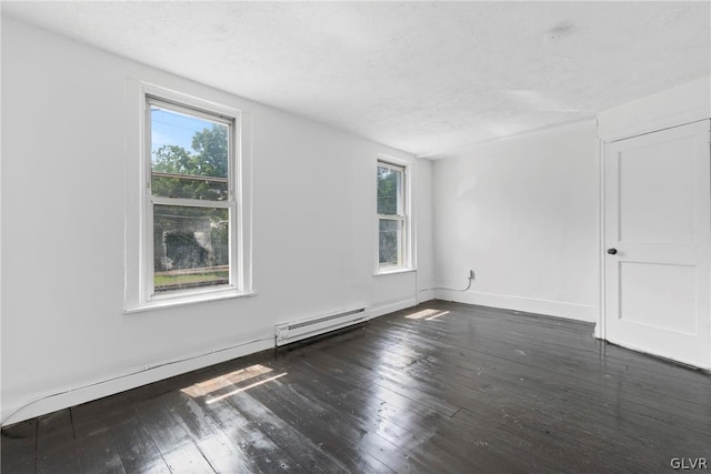 unfurnished room featuring plenty of natural light, a baseboard heating unit, and wood-type flooring