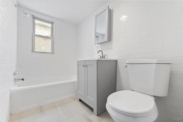 full bathroom with tile walls, vanity, and toilet