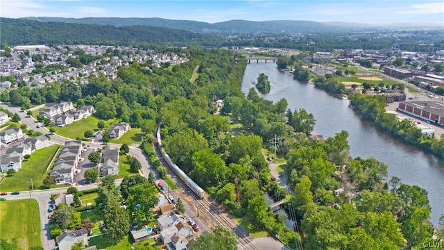 birds eye view of property with a water and mountain view