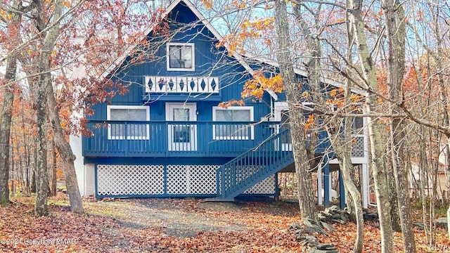 back of house featuring a deck