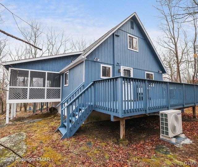 back of house with a wooden deck, ac unit, and a sunroom