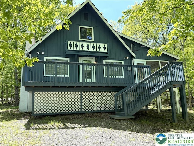 back of house with stairway and a wooden deck