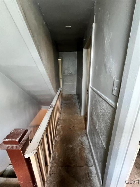 staircase featuring concrete flooring