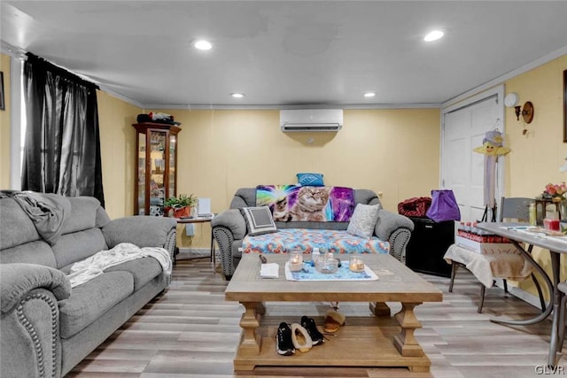 living room with a wall unit AC, crown molding, and light hardwood / wood-style flooring