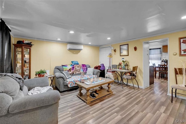 living room featuring ornamental molding, a wall mounted air conditioner, and light wood-type flooring