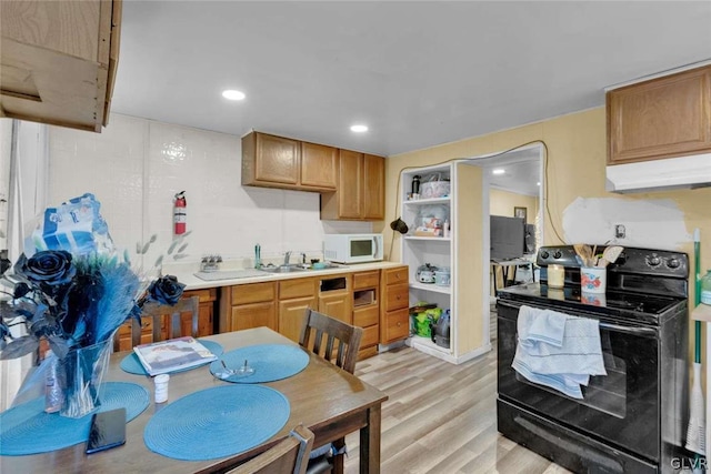 kitchen featuring electric range and light hardwood / wood-style floors