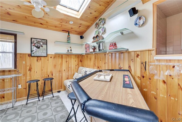 rec room featuring wooden ceiling, ceiling fan, a skylight, and carpet flooring