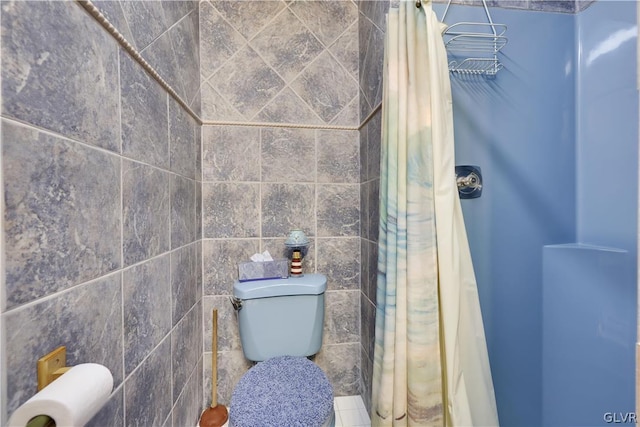 bathroom with tile walls, walk in shower, and toilet