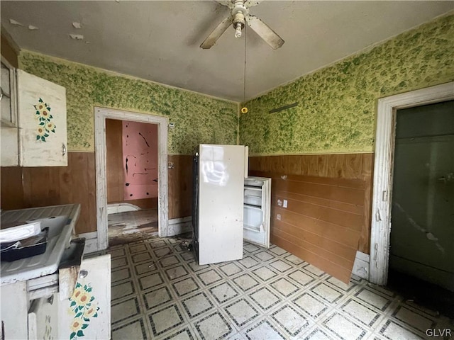 kitchen featuring electric range, light tile patterned floors, and ceiling fan