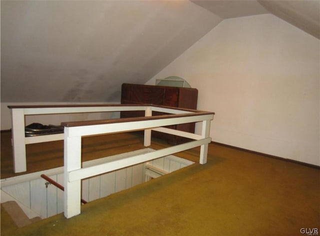 bonus room with carpet floors and vaulted ceiling